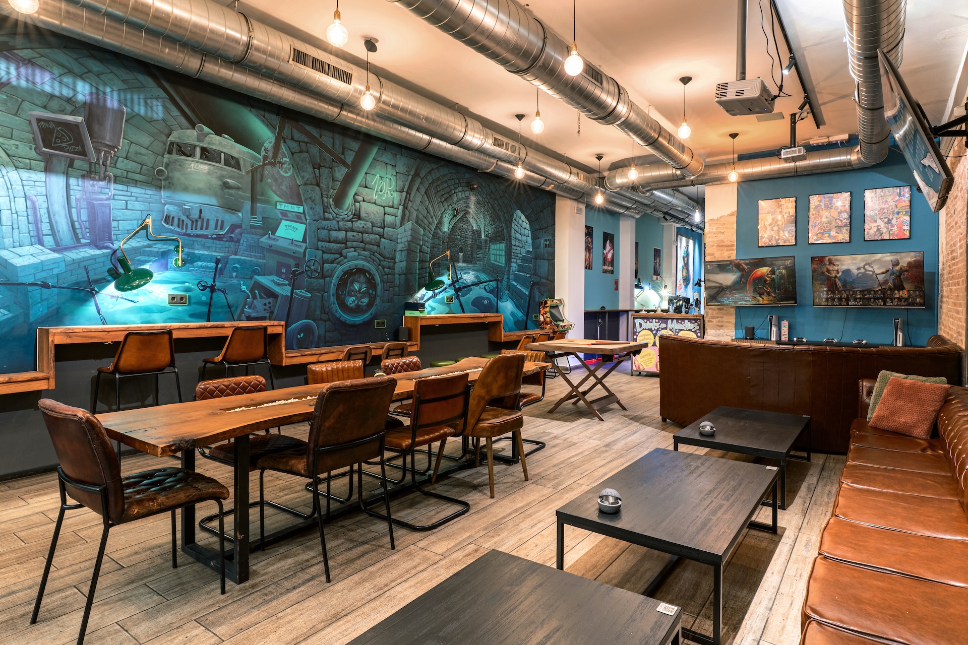 Main room of 1UP weed club with large table and comic-style mural